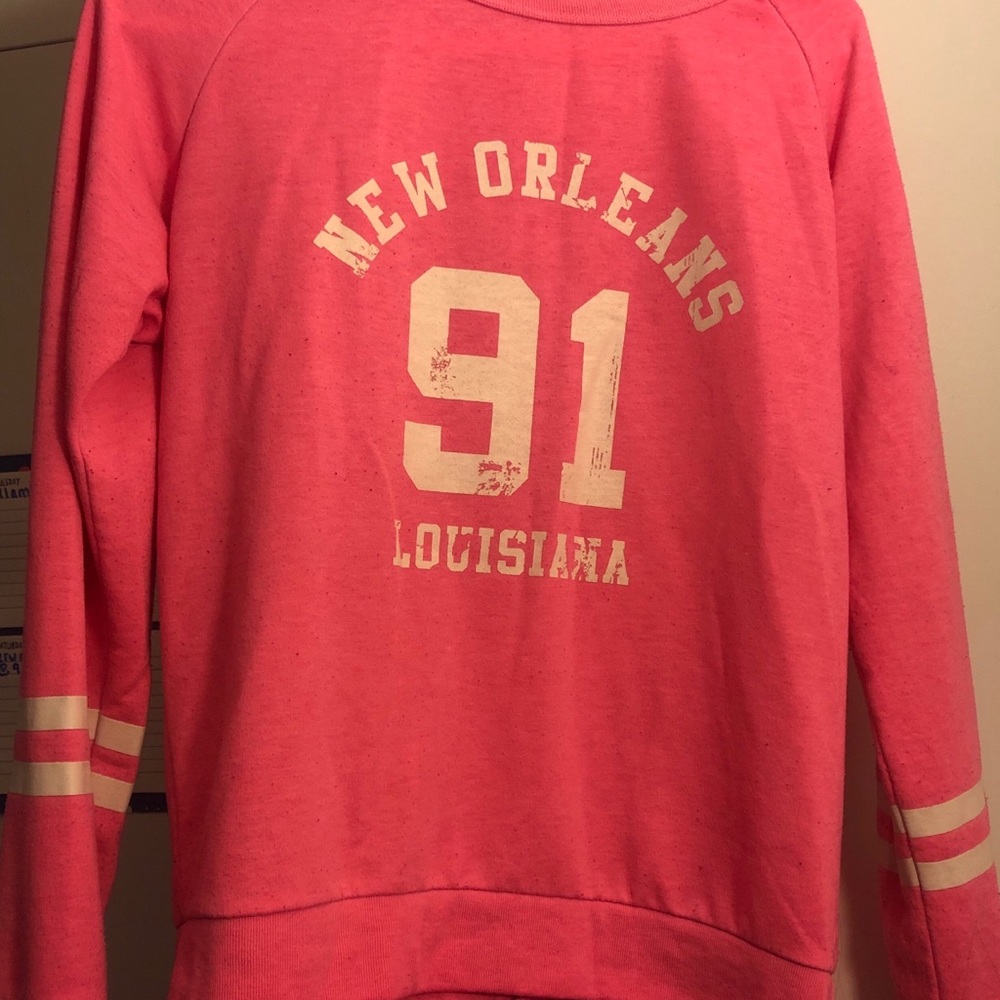 Pink crewneck sweater.